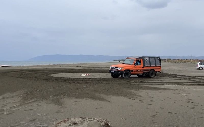 4x4 tour driving on a wide sandy beach on the Albanian coast