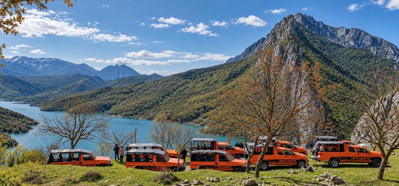 Off Limits jeeps parked by a mountain lake in Albania