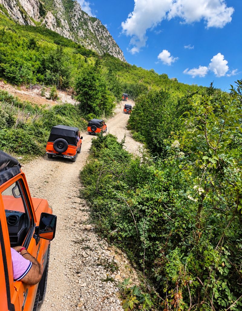 Jeep safari convoy on a narrow mountain trail near Bovilla